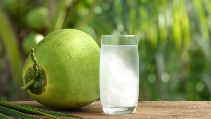 Glass,Of,Coconut,Juice,With,Blurred,Coconut,Tree,Background. coconut water benefits